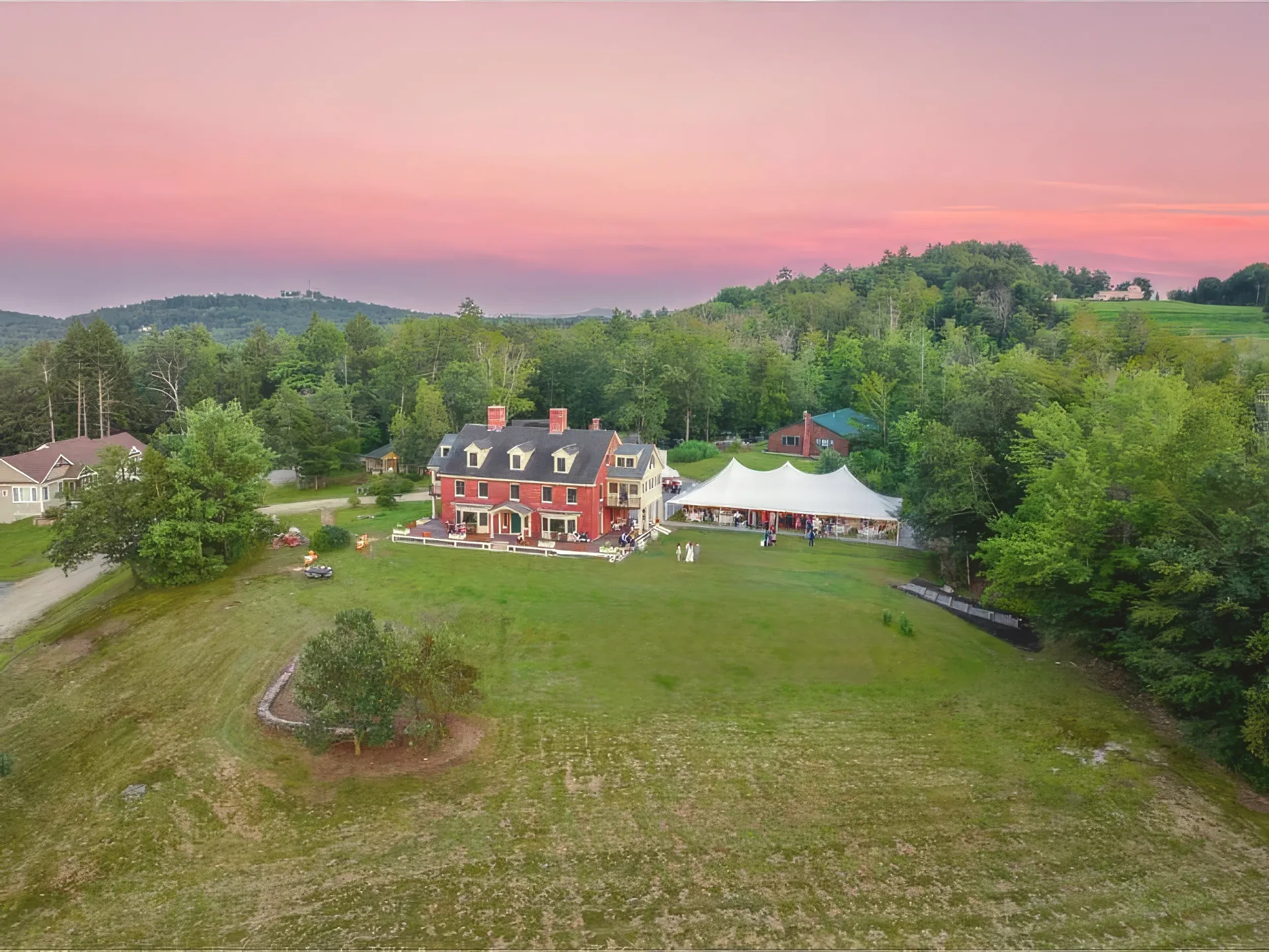 Aerial view of the Inn, an event tent, and the surrounding hills at sunset