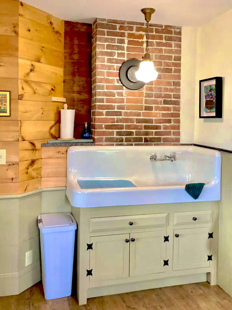 Cottage bathroom with a brick wall and bathtub vanity